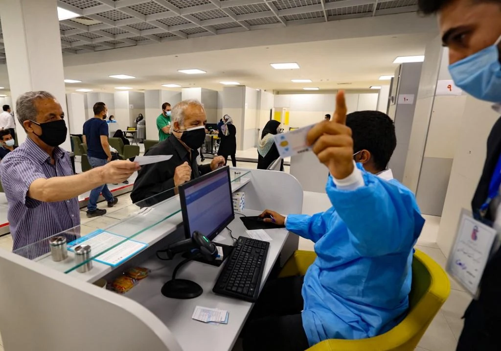 The Iranian government for being slow to vaccinate people — only about 6.5 million of the 83 million population are fully inoculated. Above, residents register for a jab at a vaccination center in Tehran. (AFP)