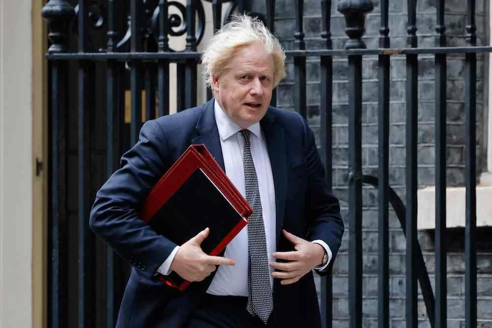 Britain's Prime Minister Boris Johnson walks from 10 Downing Street to the press briefing room at 9 Downing Street to chair an emergency meeting with G7 counterparts over the Afghanistan crisis. (AFP)