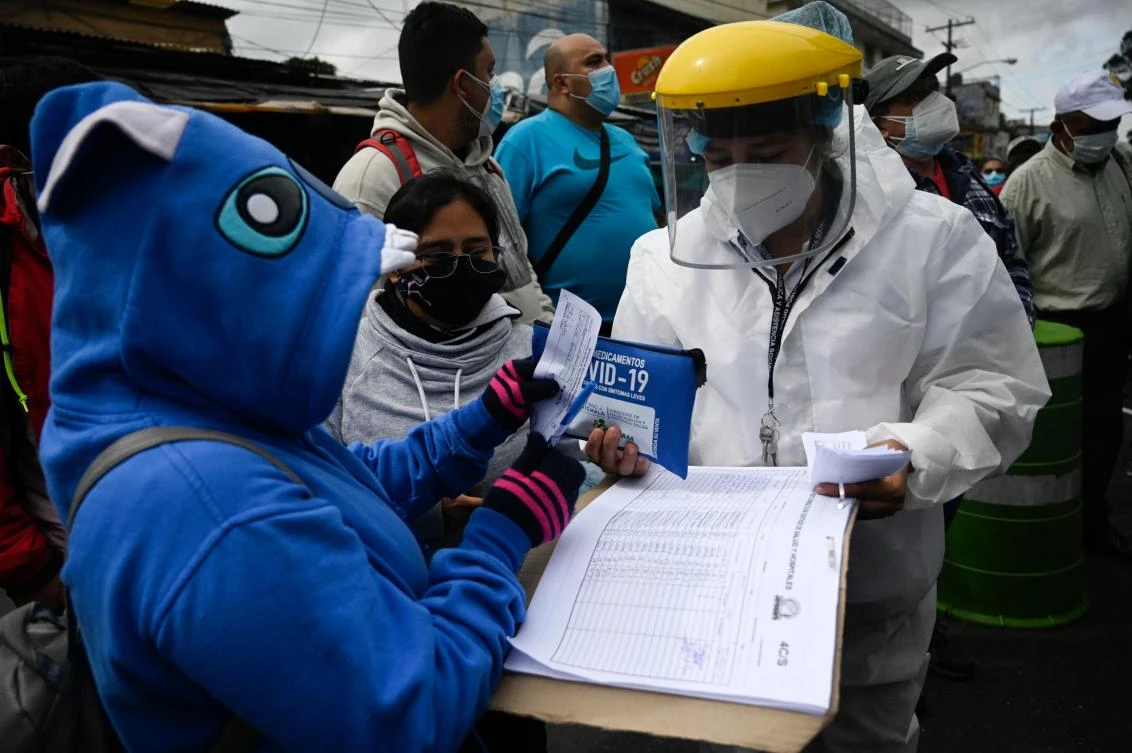 Health worker delivers medicines to Covid-19 patients at a mobile laboratory in Guatemala. International scientists dispatched to China by WHO to find out where the coronavirus came from said Wednesday the search has stalled. (AFP)