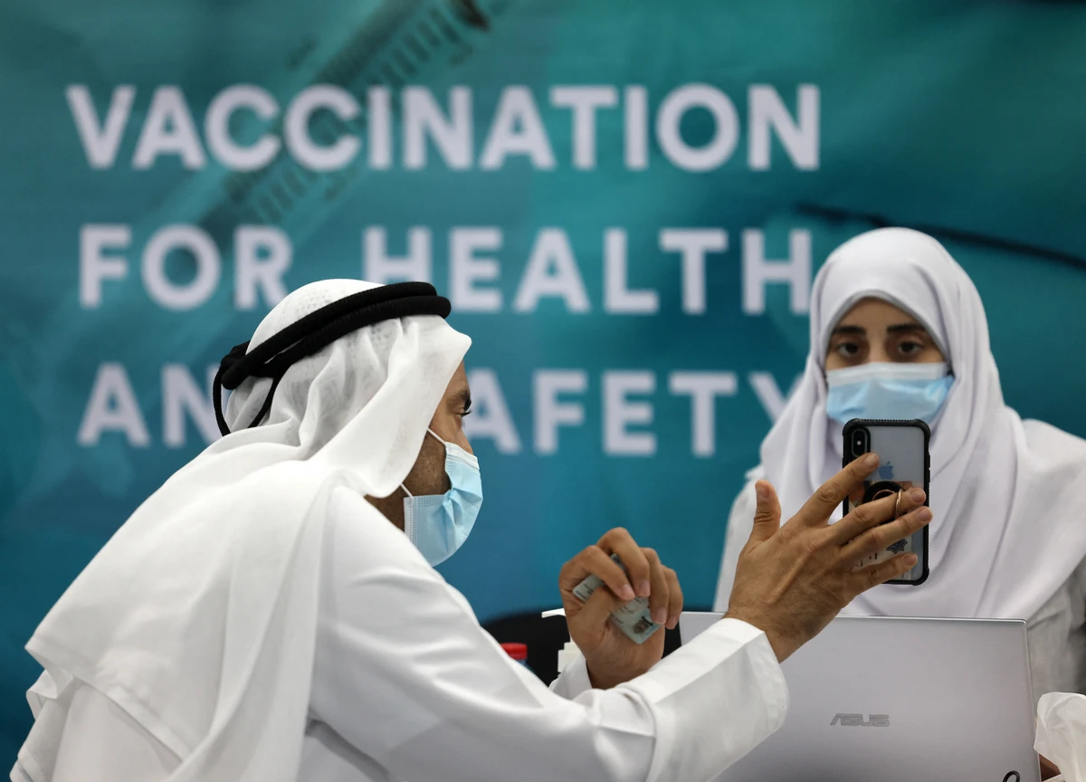 A man registers before receiving a dose of vaccine against the coronavirus at a vaccination centre set up at the Dubai International Financial Center. (File/AFP)