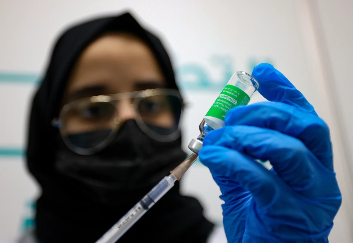 A health worker prepares an injection against the coronavirus at a vaccination centre, set up at the Dubai International Financial Center. (File/AFP)