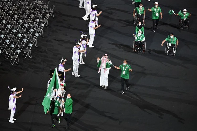 Sarah Al-Jumaah and Ahmed Al-Sharbatly carry the Saudi flag at the Tokyo 2020 Paralympic Games opening ceremony. (AFP)