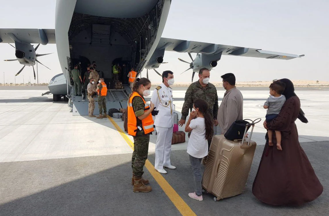 Afghan collaborators with the Spanish mission in Afghanistan and their families, arrive in Dubai prior to flying to Spain. (File/AFP)