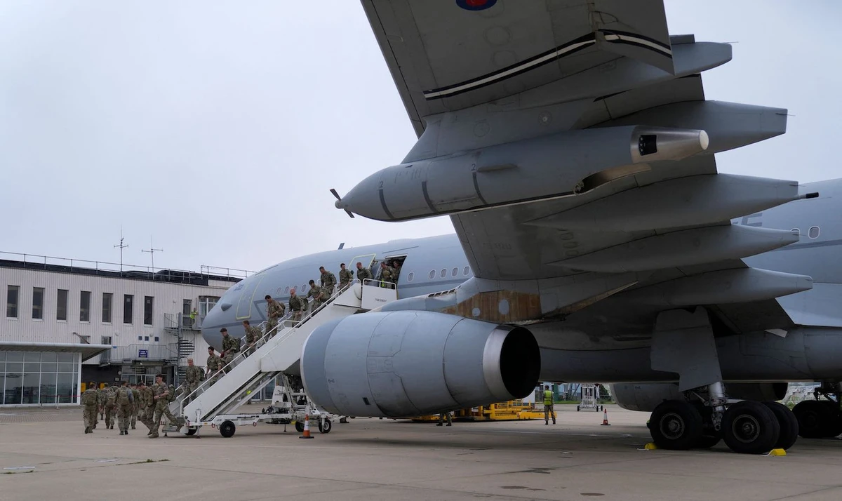 Members of the British armed forces walk to the air terminal after disembarking at Brize Norton, Oxfordshire on August 28, 2021. (AFP)