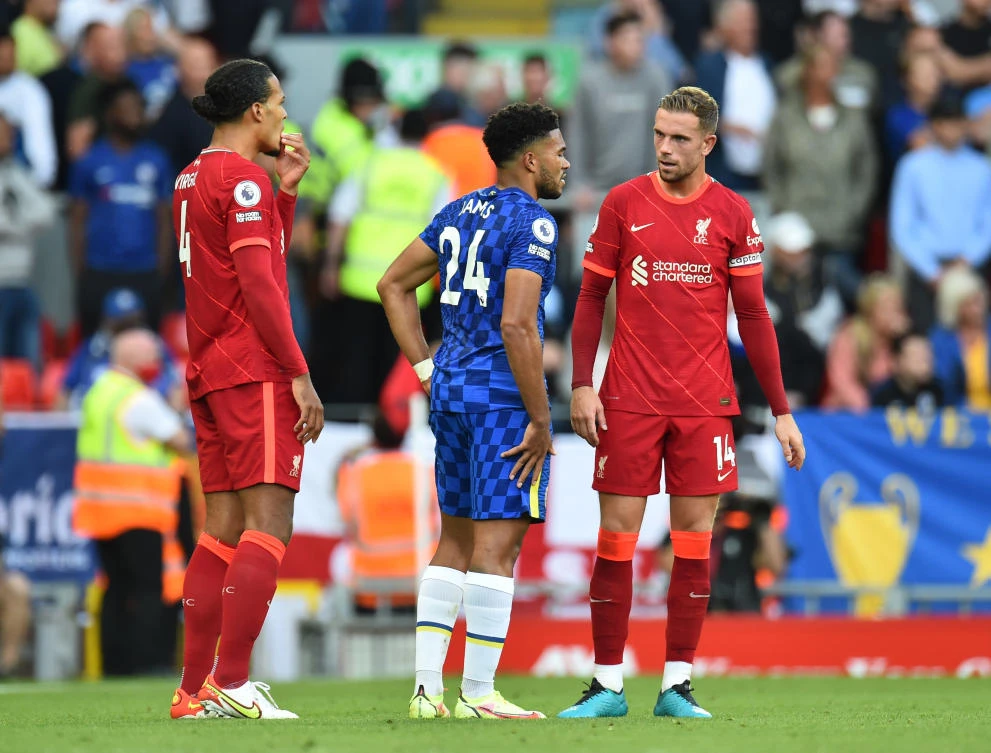 Chelsea’s Reece James with Liverpool’s Jordan Henderson after receiving a red card during their Premier League match at Anfield on Saturday.(Reuters)