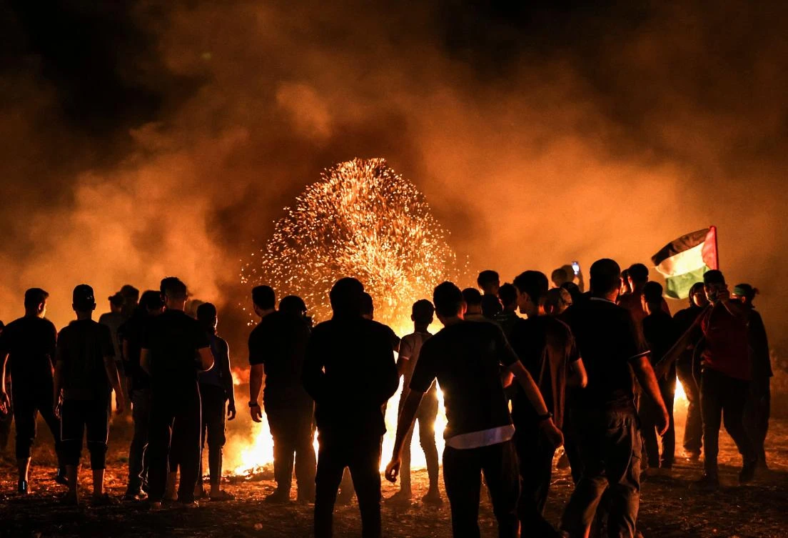 Palestinian protesters burns tires following a demonstration along the border between the Gaza Strip and Israel east of Gaza City on Aug. 28, 2021. (AFP)