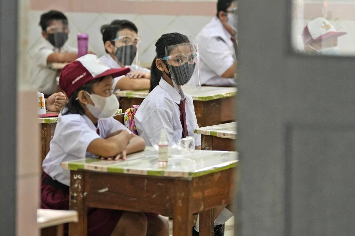 Students wearing face masks to help prevent the spread of COVID-19 attend class during the first day of school reopening at an elementary school in Jakarta, Indonesia, Monday, Aug. 30, 2021. (AP)