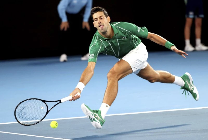 Serbia's Novak Djokovic reaches for a forehand return to Germany's Jan-Lennard Struff during their first round singles match the Australian Open tennis championship in Melbourne, Australia, Monday, Jan. 20, 2020. (AP)