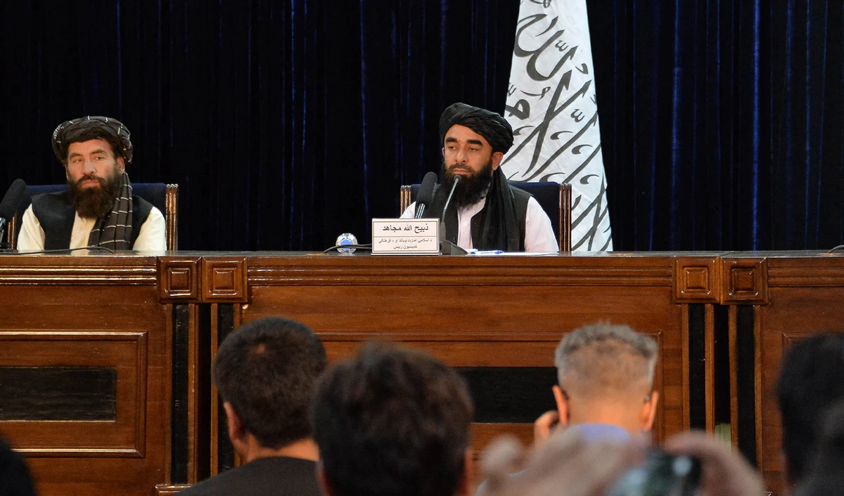 Taliban spokesperson Zabihullah Mujahid (R) listens to a question during a press conference in Kabul, Afghanistan, on August 24, 2021. (AFP)
