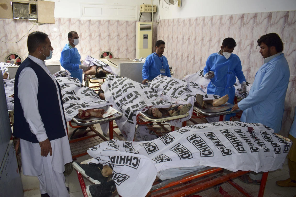Paramedical personnel stand next to the bodies of suspect militants who were killed by security forces in Quetta, Pakistan on Aug. 31, 2021. (AP)
