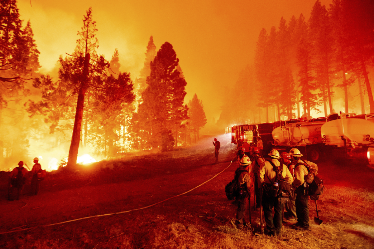 Firefighters work to stop a wildfire from spreading to Eldorado National Forest in California on Aug. 26, 2021. Wildfires breaking out simultaneously in any countries are blamed on climate change. (AP Photo/Noah Berger)
