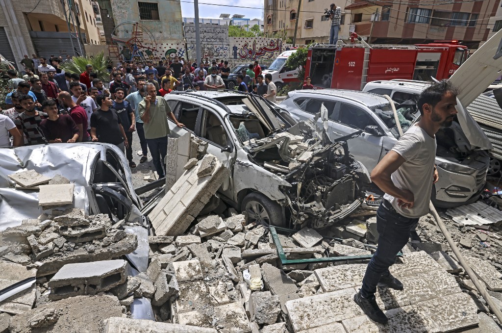 Palestinians inspect a site hit during an Israeli airstrike in Gaza City in May. (AFP/File)