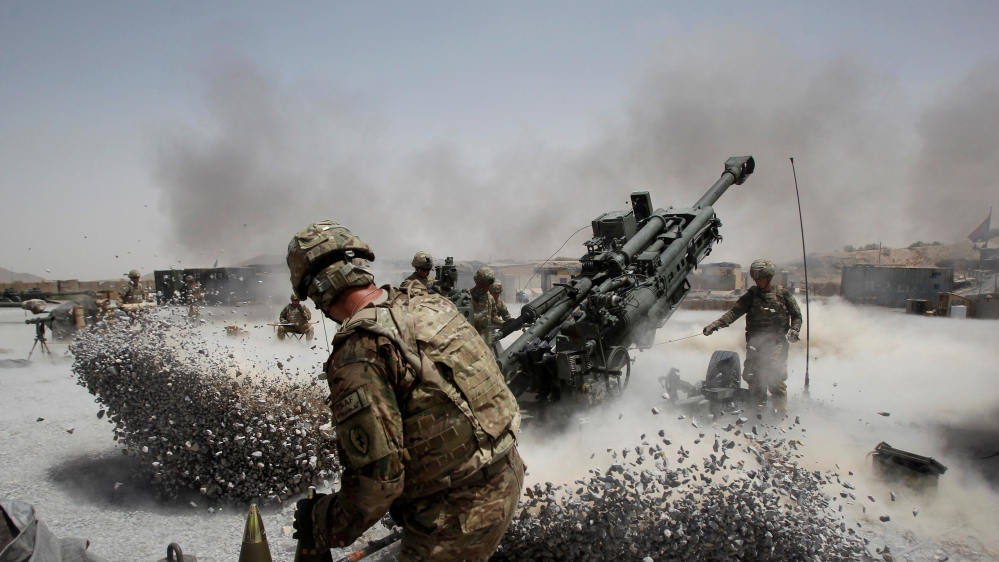 US soldiers fire a howitzer artillery piece at Seprwan Ghar forward fire base, Panjwai district, Kandahar province, Afghanistan, June 12, 2011. (Reuters)