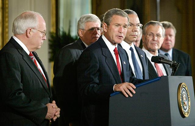 George W. Bush before signing the congressional resolution authorizing U.S. use of force against Iraq, White House, Oct. 16, 2002. (Reuters)