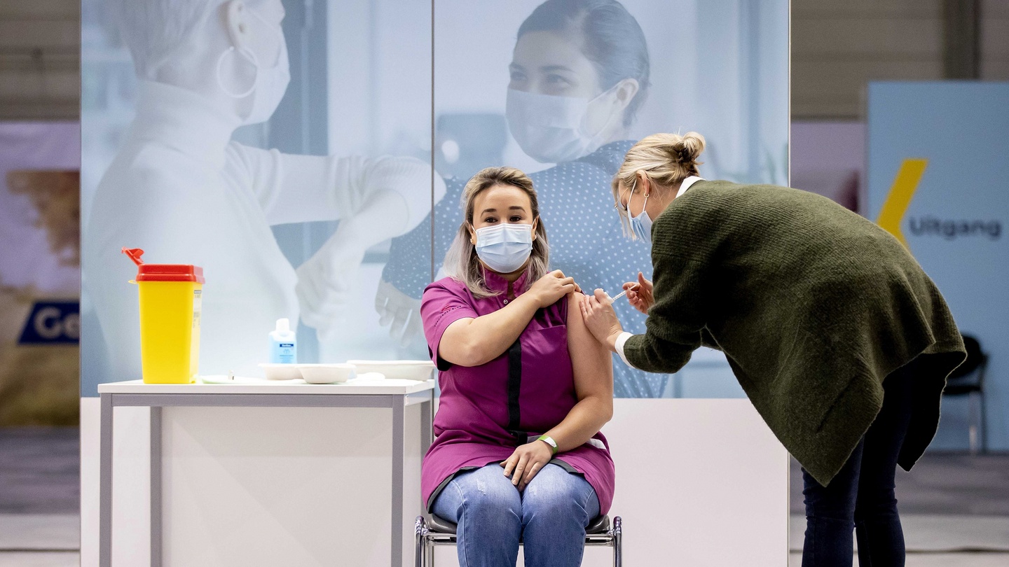 Sanna Elkadiri, the first Dutch recipient of a COVID vaccine, gets a shot of the Pfizer-BioNTech vaccine, Veghel, Netherlands, Jan. 6, 2021. (AP Photo)