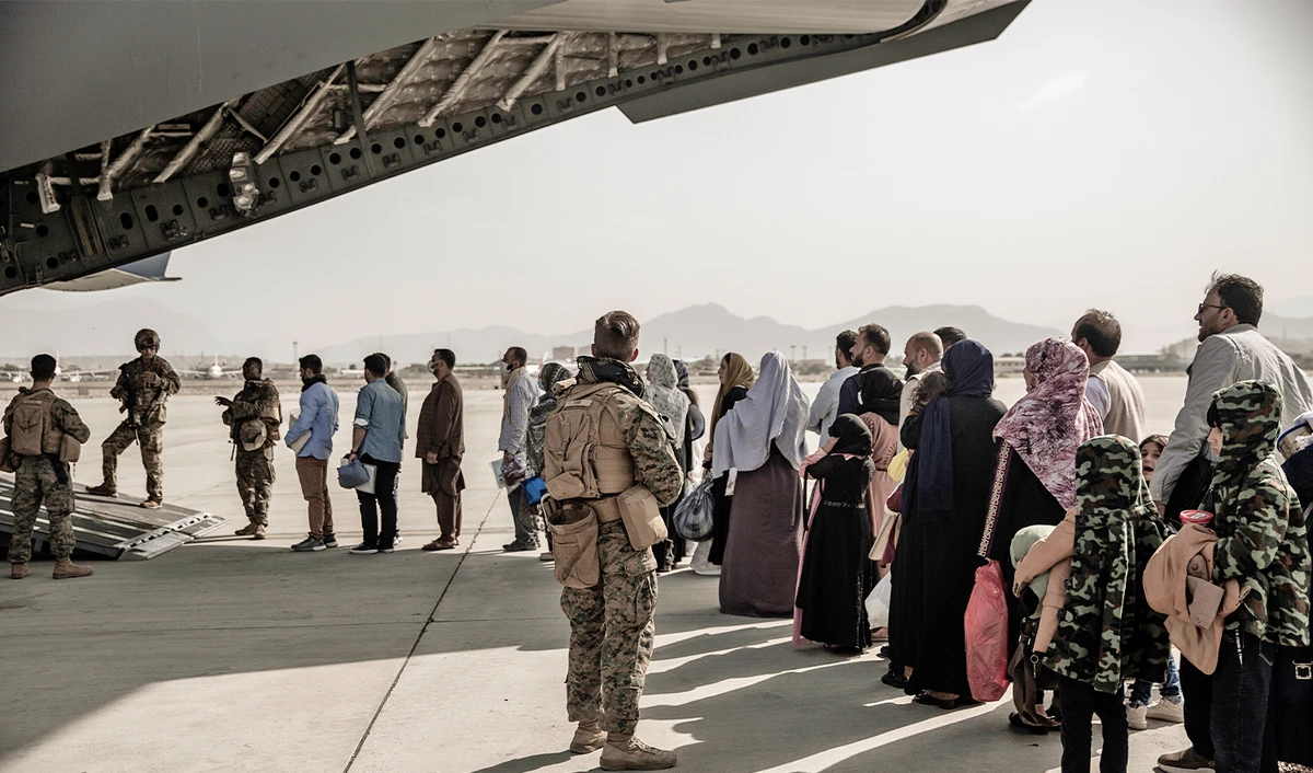 Evacuees wait to board a Boeing C-17 Globemaster III during an evacuation at Hamid Karzai International Airport in Kabul, Afghanistan, on August 30, 2021. (Photo courtesy: U.S. Marine Corps via AP)
