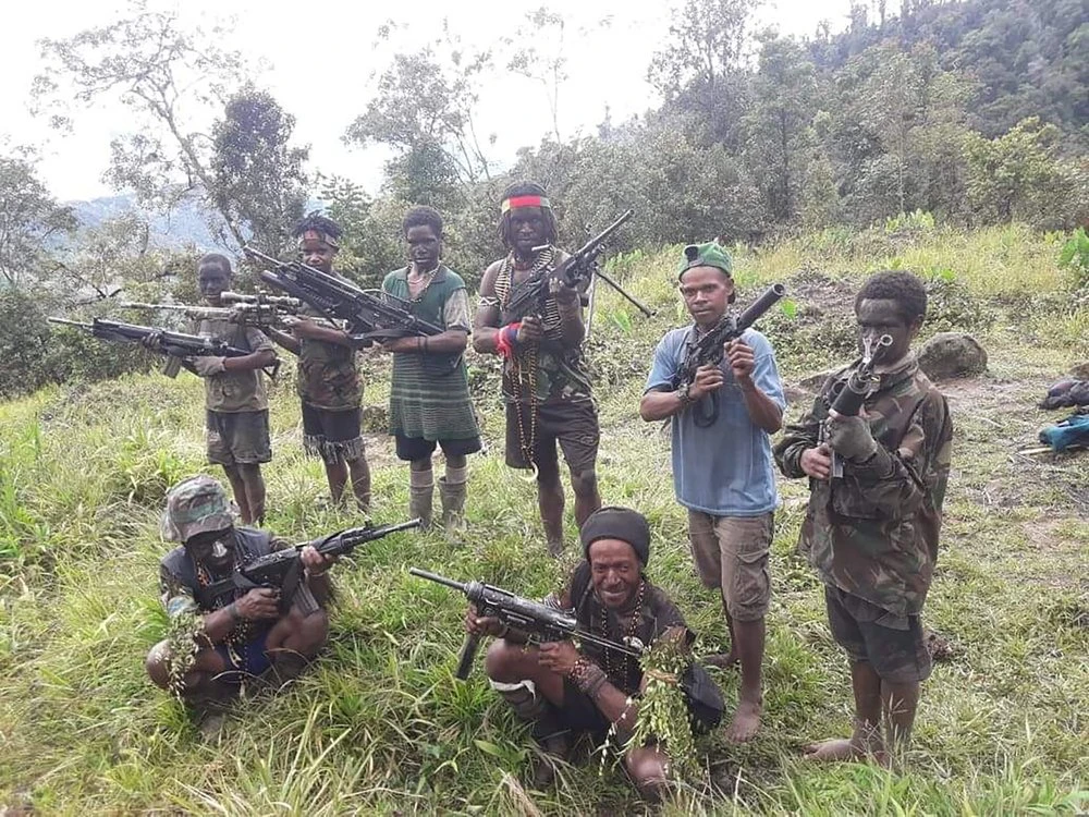 In this photo taken in May 2019, and released by the West Papua Liberation Army-Free Papua Organization, men and boys from the West Papua Liberation Army pose with weapons in the Nduga region of the central highlands, Papua province, Indonesia. (AP)