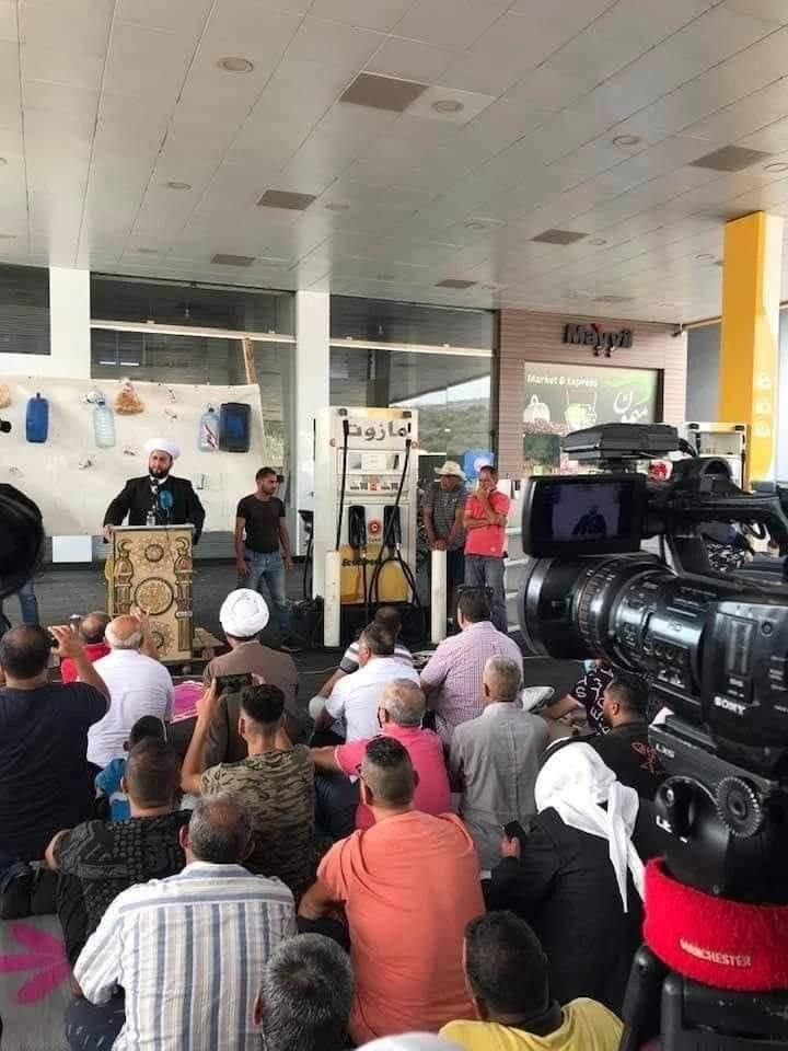 Residents gather in a gas station in southern Lebanon during Friday prayers. (HO)