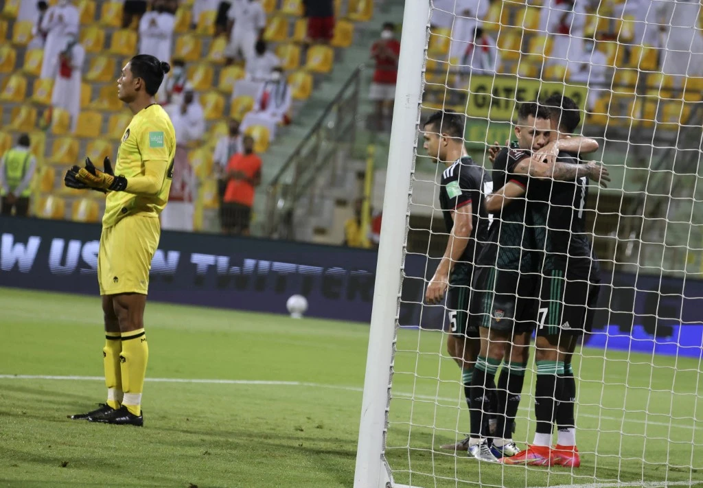 UAE's Ali Mabkhout (R) celebrates with team mates after scoring during the 2022 FIFA World Cup qualification group g football match between the United Arab Emirates and Indonesia at the Zabeel Stadium Stadium in Dubai on June 11, 2021. (File/AFP)