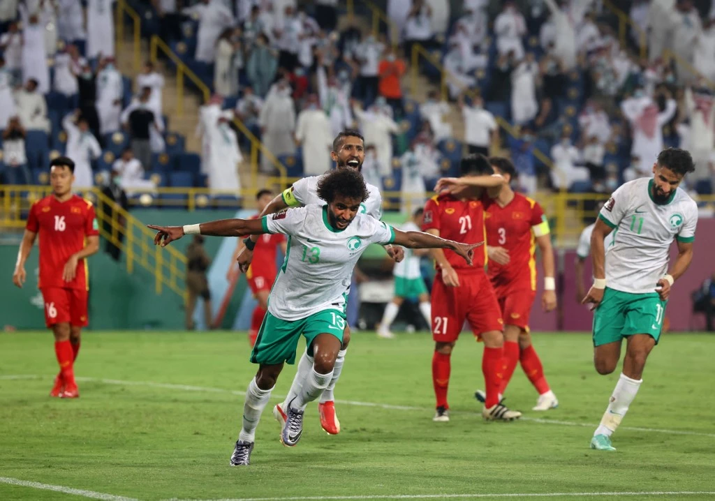 Saudi Arabia's Yasser al-Shahrani celebrates with teammates during the 2022 Qatar football World Cup Asian qualification match between Saudi Arabia and Vietnam. (AFP)