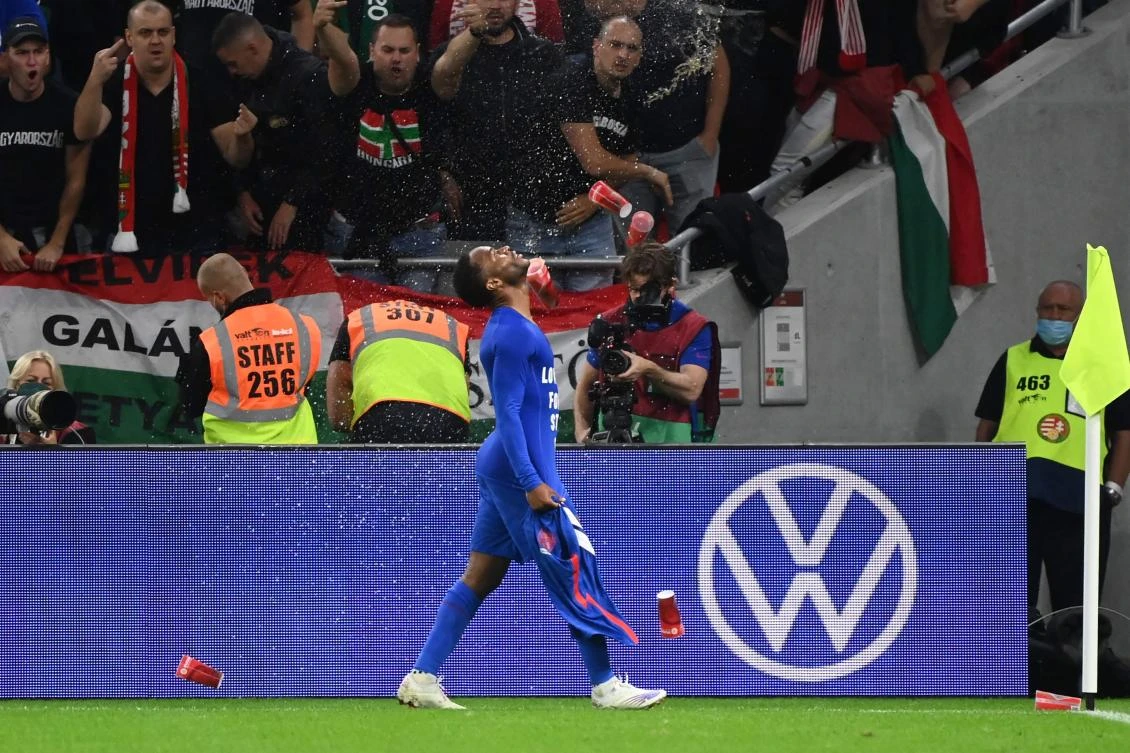 Hungary’s fans react throwing cups of beer at England’s forward Raheem Sterling as he celebrates scoring the opening goal during World Cup Qatar 2022 qualification match between against England, at the Puskas Arena in Budapest on Thursday. (AFP)
