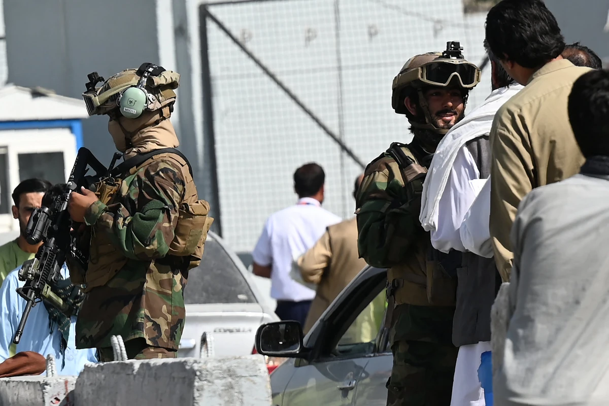 Members of the Taliban Badri 313 military unit stand guard at a check point as airport workers queue to enter to the Kabul International Airport in Kabul on September 4, 2021. (AFP)