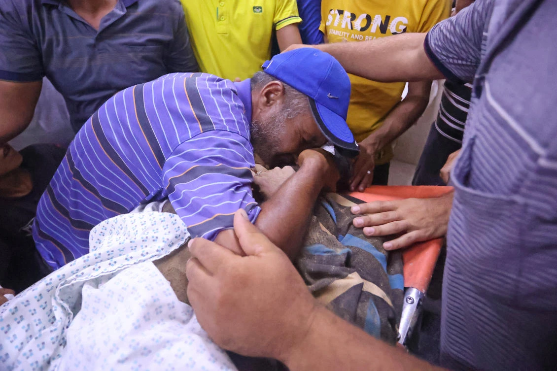 A relative mourns over the body of Issa Abu Al-Hassum, who had gone missing in a smuggling tunnel near the Rafah border crossing to Egypt, at a hospital morgue in the Gaza Strip on Sept. 3, 2021. (File/AFP)