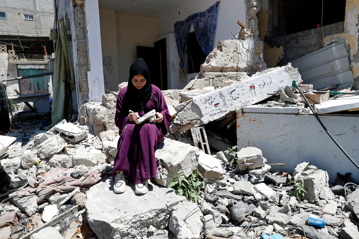 A woman outside her family's house in Rafah refugee camp, southern Gaza Strip, June 15, 2021. (AP)