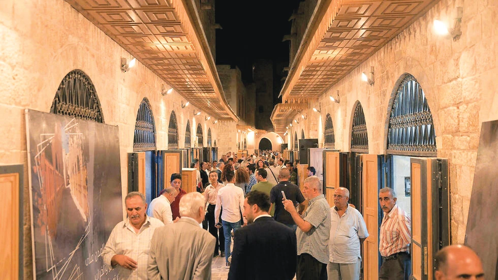 People walk through the reopened Khan Al-Harir souk in Aleppo. (AFP)