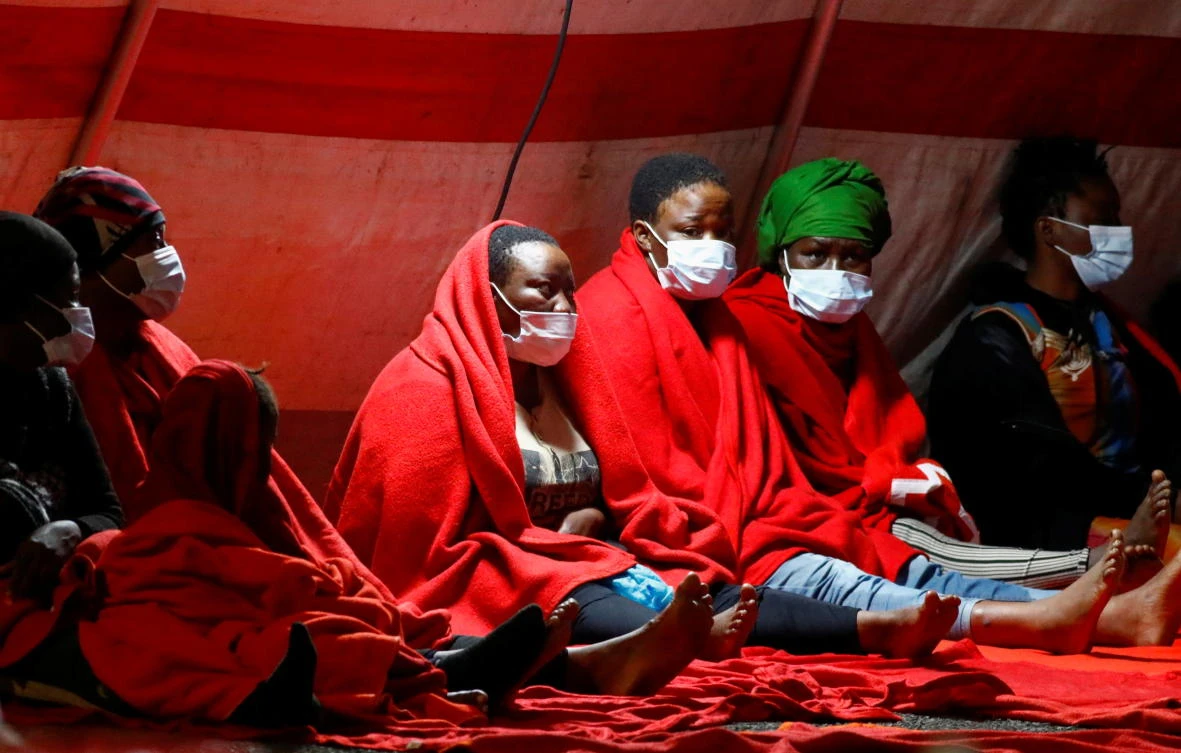 A group of migrants rests in a Red Cross tent after disembarking from a Spanish coast guard vessel in the port of Arguineguin, in the island of Gran Canaria, Spain, September 8, 2021. (Reuters)