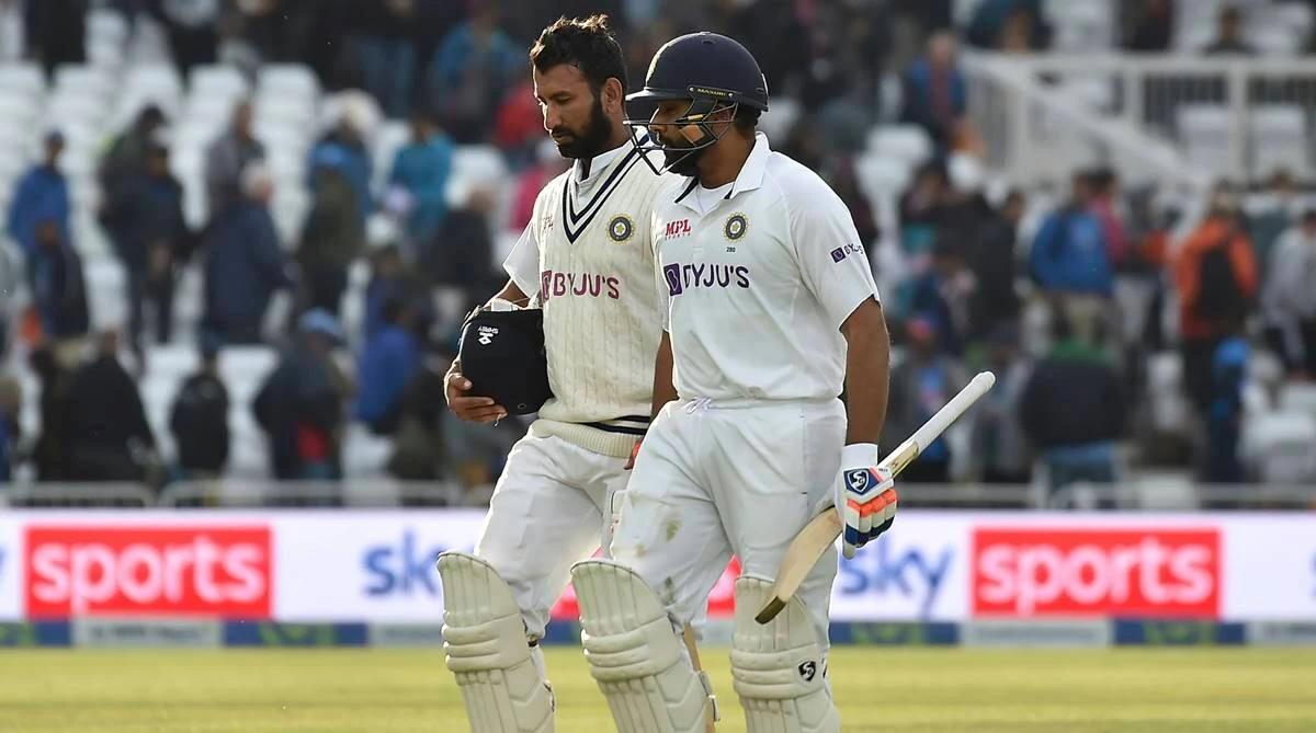 India's Rohit Sharma, right, and Cheteshwar Pujara leave the field. (AP)