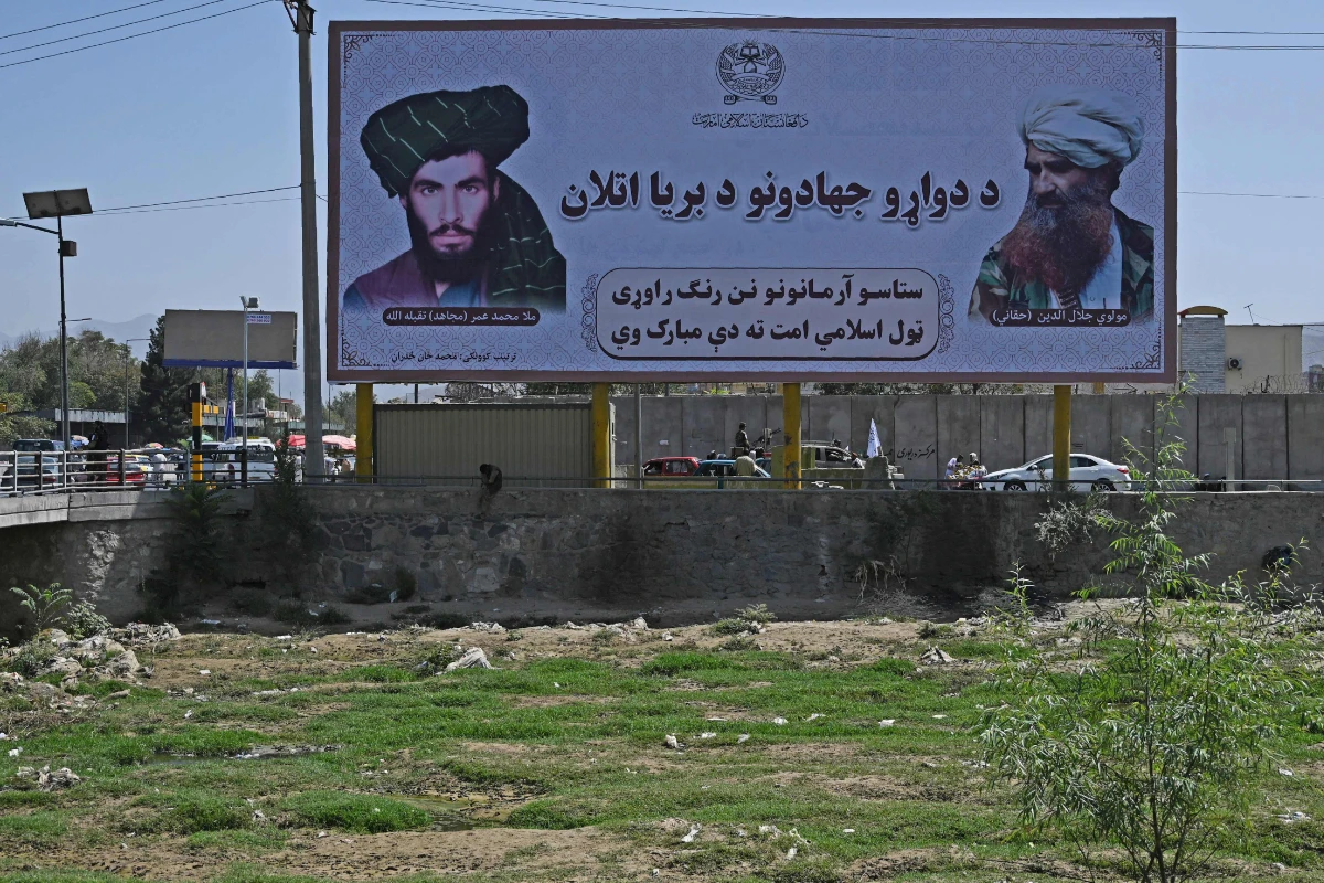 A billboard with the images of late Afghan Taliban leader Mullah Omar (L) and late Afghan leader of the Haqqani network Jalaluddin Haqqani is seen along a road in Kabul on Sept. 9, 2021. (Aamir Qureshi / AFP)