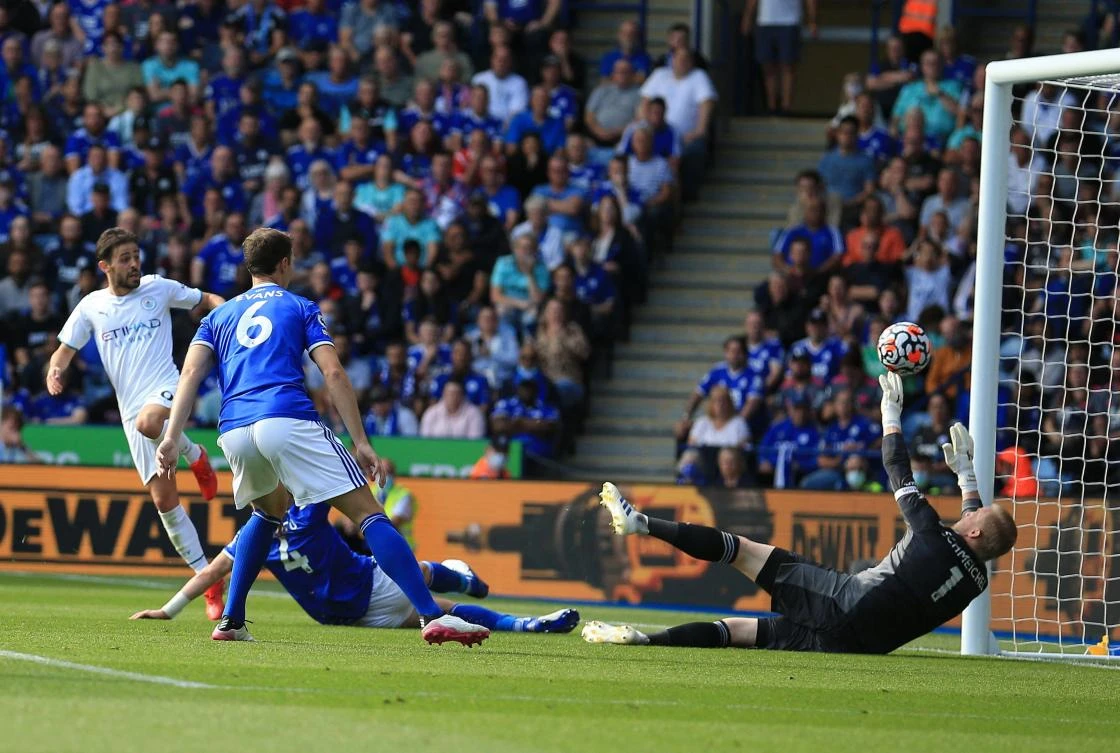 Leicester City’s Danish goalkeeper Kasper Schmeichel is beaten as Manchester City’s Portuguese midfielder Bernardo Silva scores his team’s first goal during their English Premier League match at King Power Stadium on Saturday. (AFP)