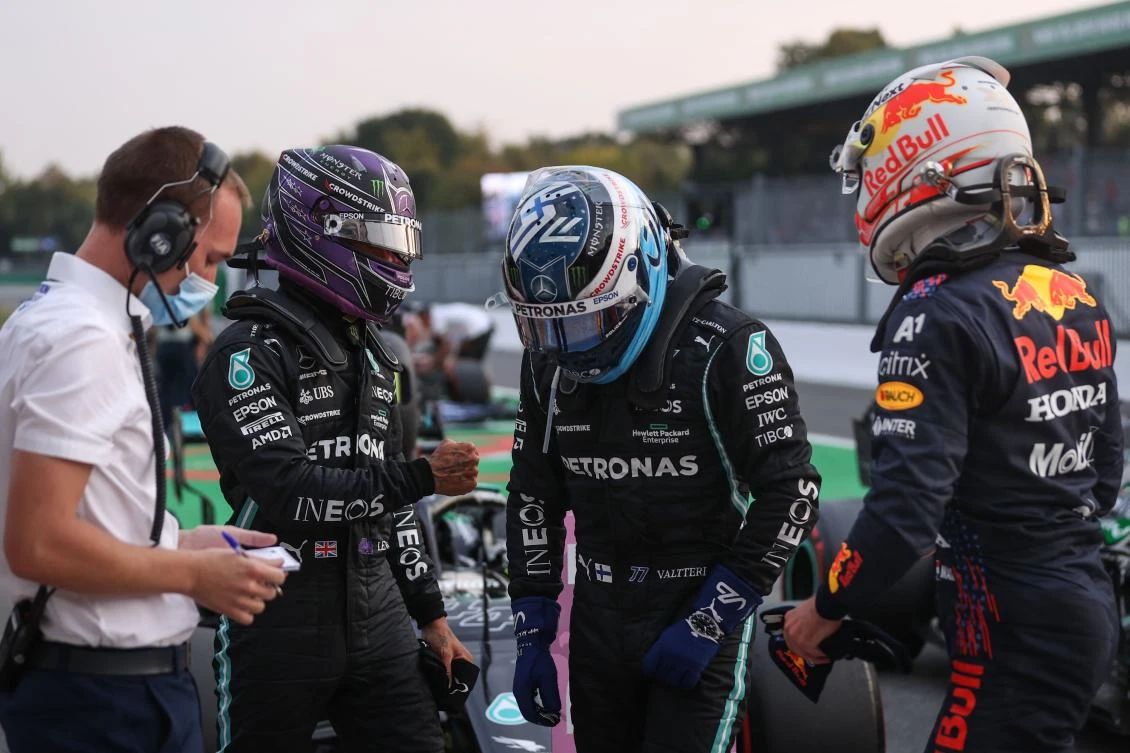 Mercedes’ British driver Lewis Hamilton greets Mercedes’ Finnish driver Valtteri Bottas next to Red Bull’s Dutch driver Max Verstappen after qualifying sessions at Autodromo Nazionale circuit in Monza ahead of Italian F1 Grand Prix. (AFP)