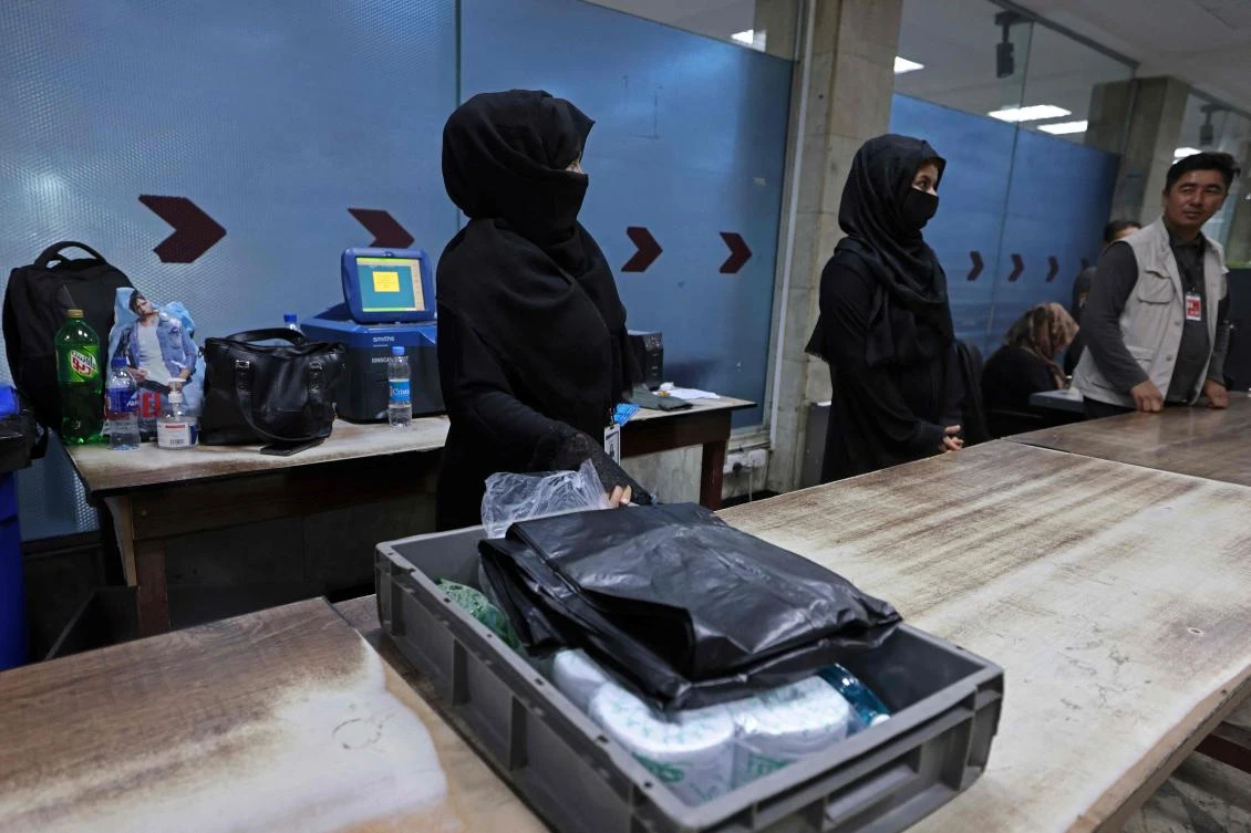 Afghan women airport workers are pictured at a security checkpoint of the airport in Kabul on September 12, 2021.(AFP)