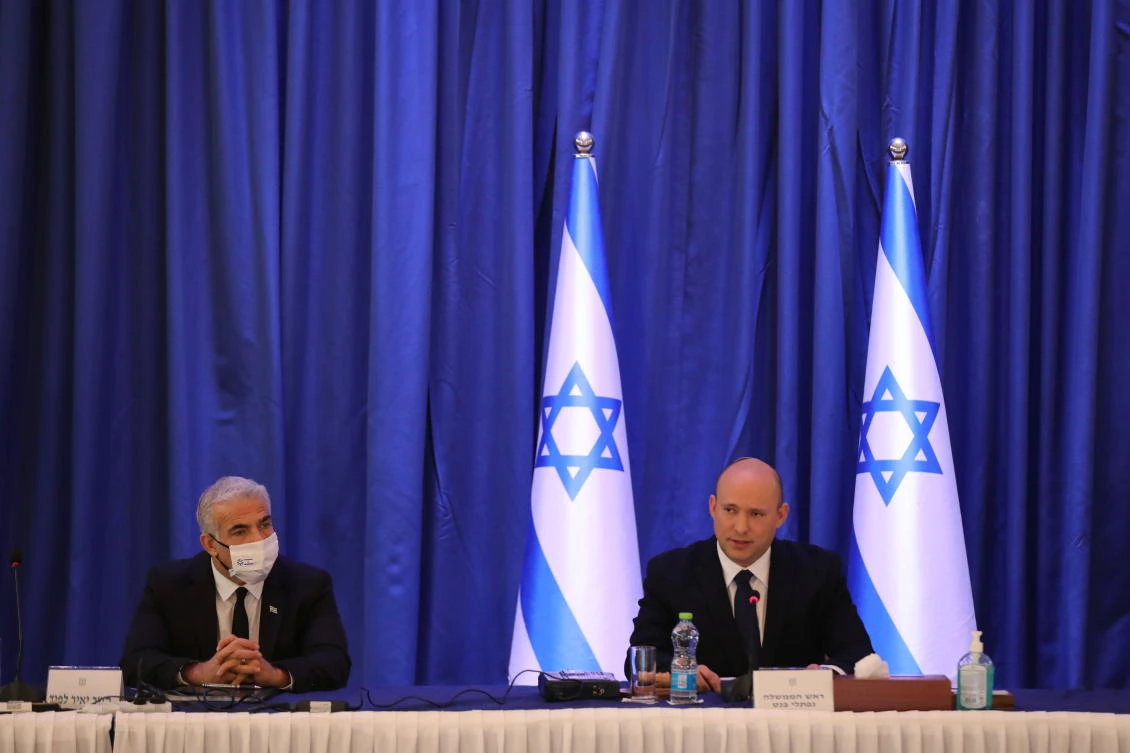 Israeli Prime Minister Naftali Bennett (R) and Foreign Minister Yair Lapid (L) attend a cabinet meeting at the Ministry of foreign affairs offices in Jerusalem, September 12, 2021. (Reuters)