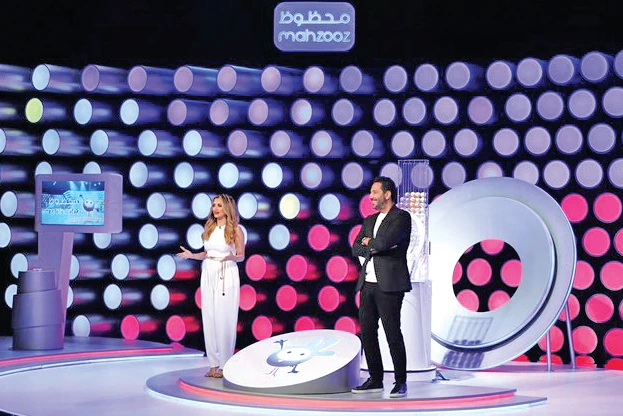 The TV set and hosts of Mahzooz, a weekly live draw in Dubai, that offers players an opportunity to win tens of millions of dirhams. Inset: Raja Wajahat. (Supplied)