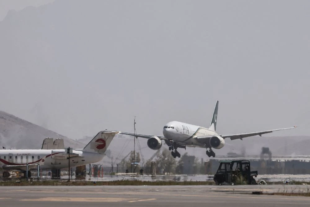 A Pakistan International Airlines plane carrying a handful of passengers lands at the airport in Kabul, the first international commercial flight since the Taliban retook power in Afghanistan. (AFP)