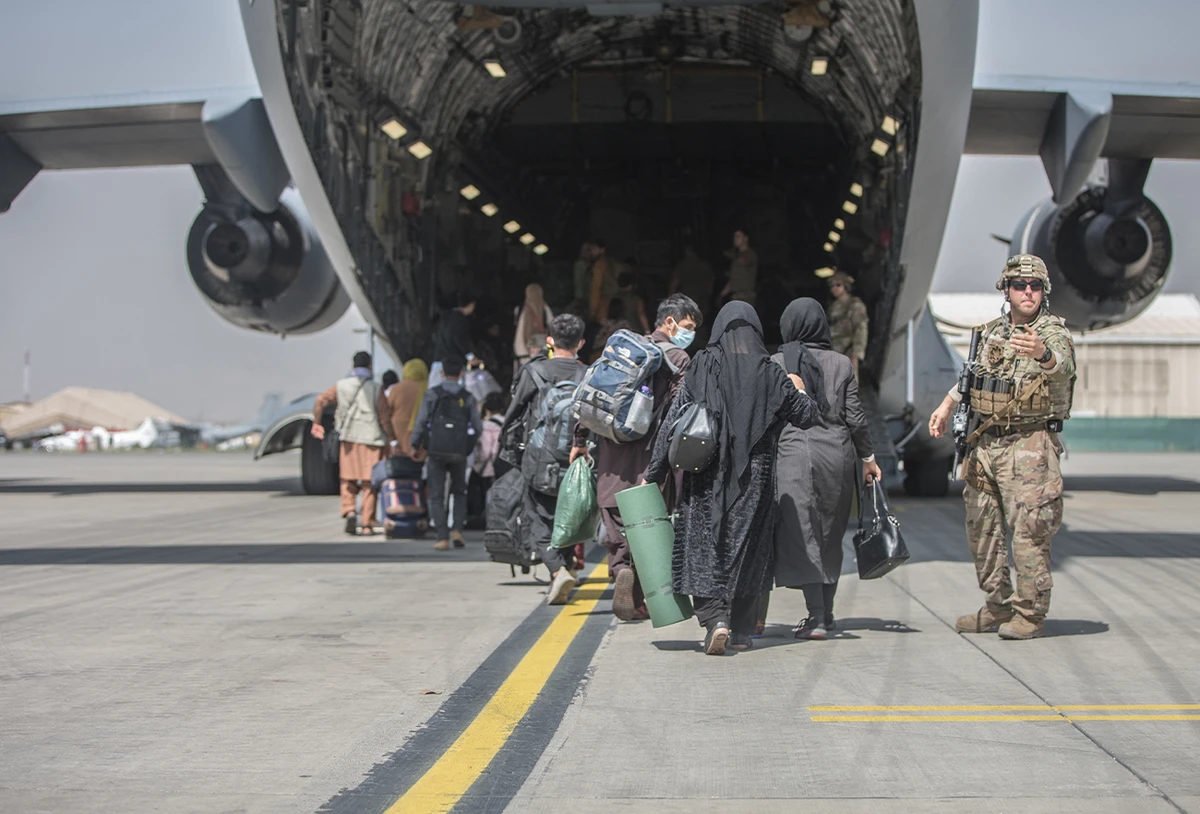 Families begin to board a US Air Force Boeing C-17 Globemaster III during an evacuation at Hamid Karzai International Airport, Kabul, Afghanistan, August 23, 2021. (AFP)