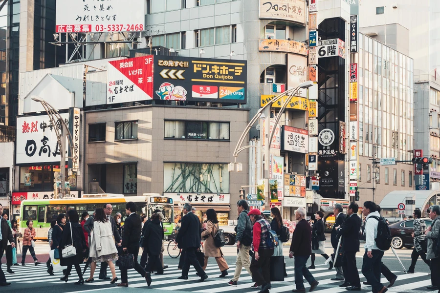 Japan cuts economic view on weaker production, spending due to COVID revival