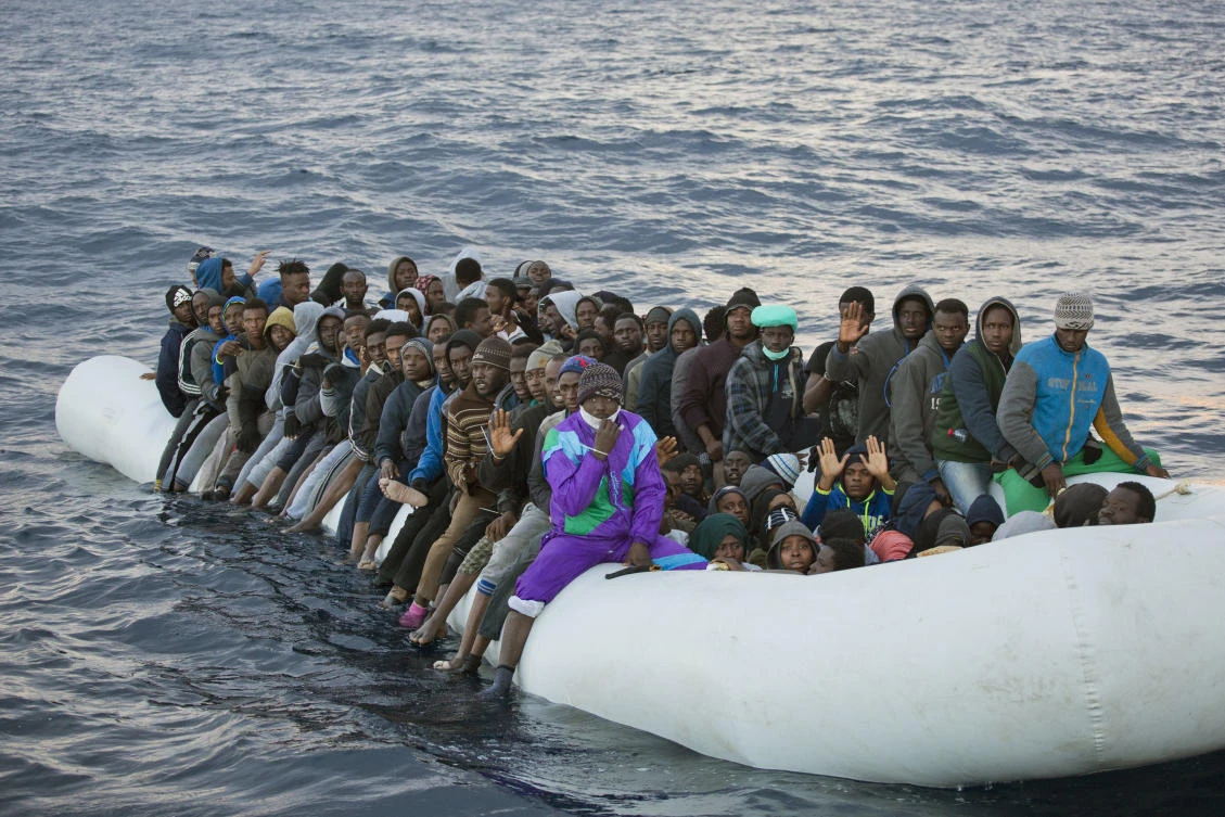 In this Feb. 3, 2017, file photo, migrants and refugees wait to be helped by members of the Spanish NGO Proactiva Open Arms, as they crowd aboard a rubber boat sailing out of control in the Mediterranean Sea about 21 miles north of Sabratha, Libya. (AP)