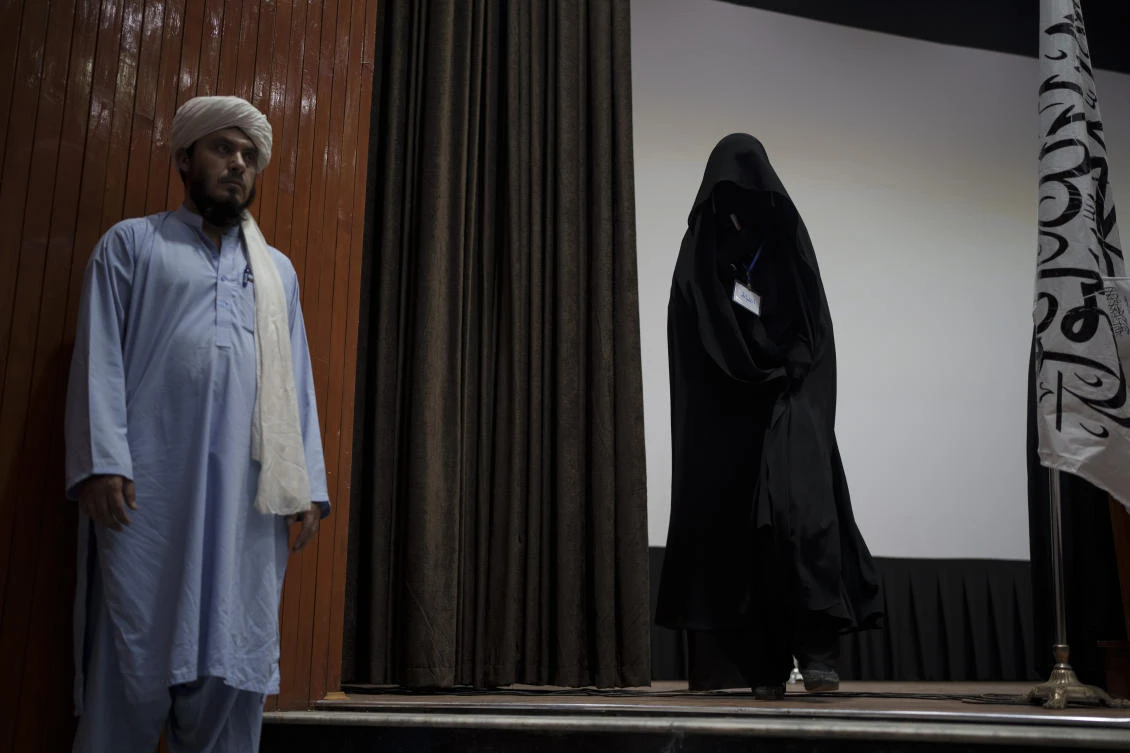 A woman walks down from the stage inside an auditorium at Kabul University's education center during a demonstration in support of the Taliban government in Kabul, Afghanistan, Saturday, Sept. 11, 2021. (AP)