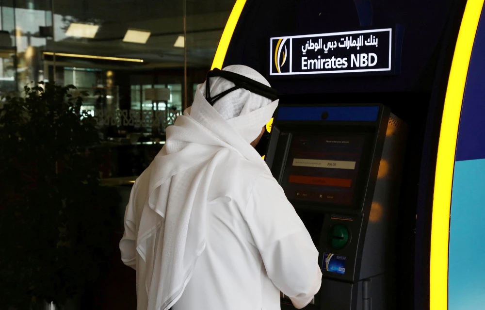 A customer uses an ATM machine at the Emirates NBD head office in Dubai, UAE. (REUTERS file photo)