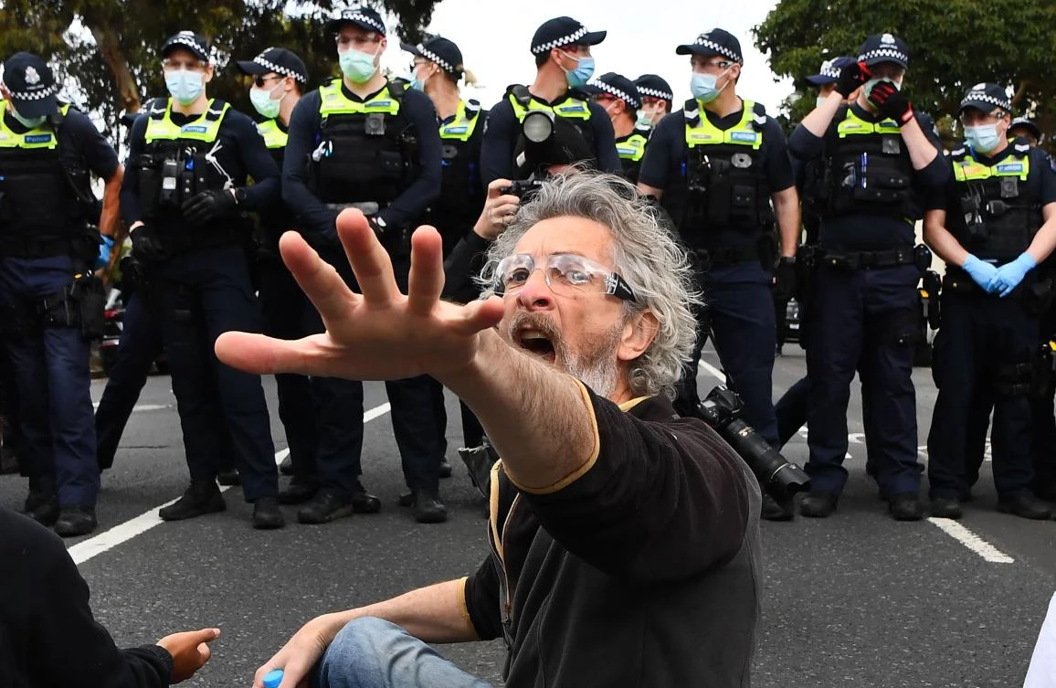 A protester confronts police during an anti-lockdown rally in Melbourne on Sept 18, 2021. (AFP)