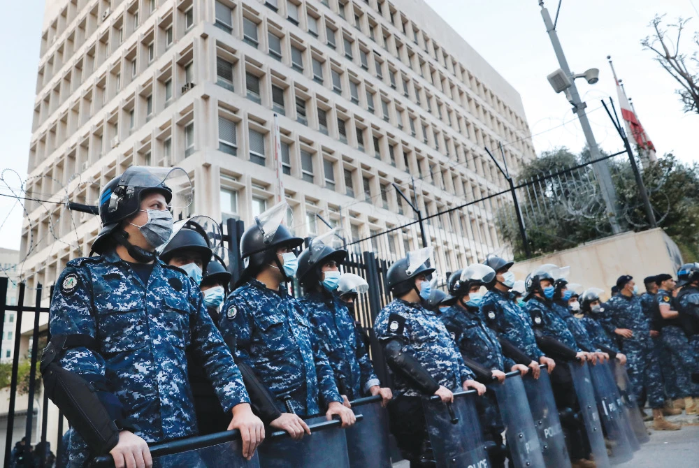 Lebanese police stand guard in front of the central bank building, where anti-government demonstrators protest against the deepening financial crisis, in Beirut. (AP/File)
