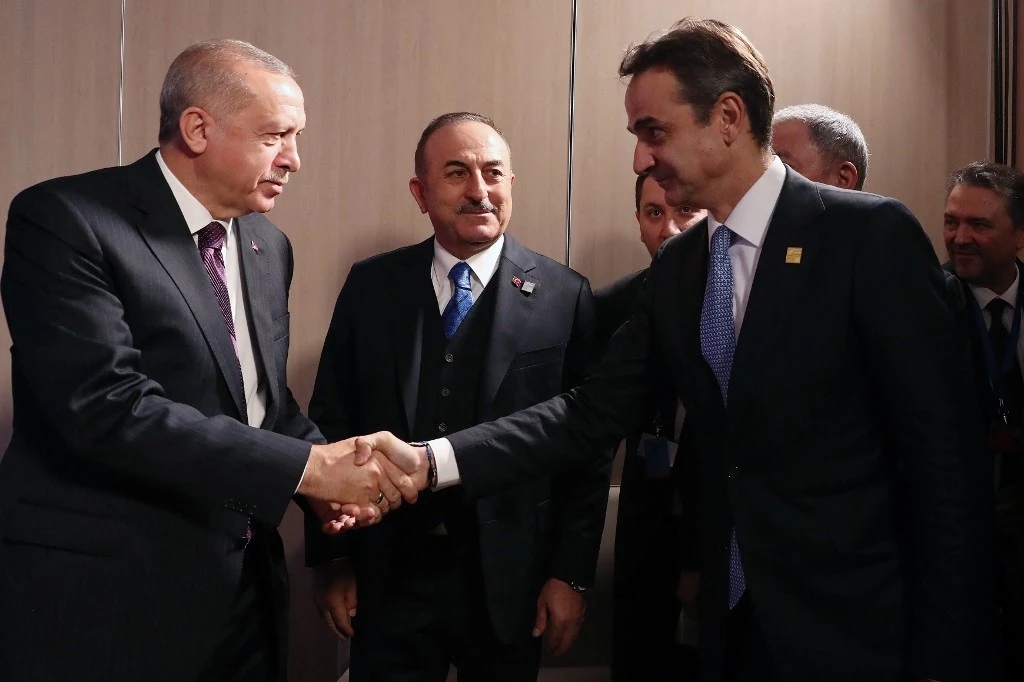 Turkish President Recep Tayyip Erdogan, left, Greek Prime Minister Kyriakos Mitsotakis, right, and Turkish Foreign Minister Mevlut Cavusoglu, center, on the sidelines of the NATO summit on Dec. 4, 2019. (Turkish Presidential Press service/AFP)