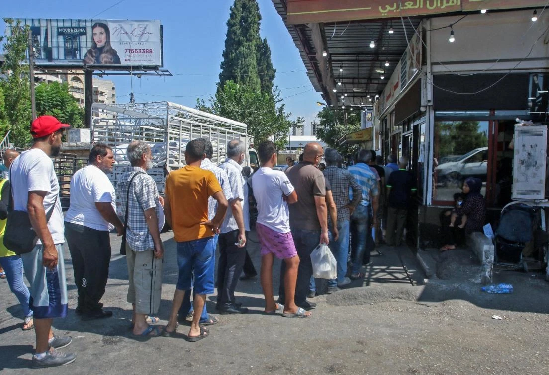 Lebanese queue for bread in front of a bakery in the southern coastal city of Sidon, on August 13, 2021, amidst a deepening economic crisis sparking various shortages of basic staples in the country. (File/AFP)