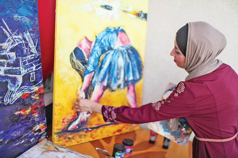 Jebril’s paintings show ‘what the woman feels, lives, faces and how she is chained,’ the artist says. (Reuters)
