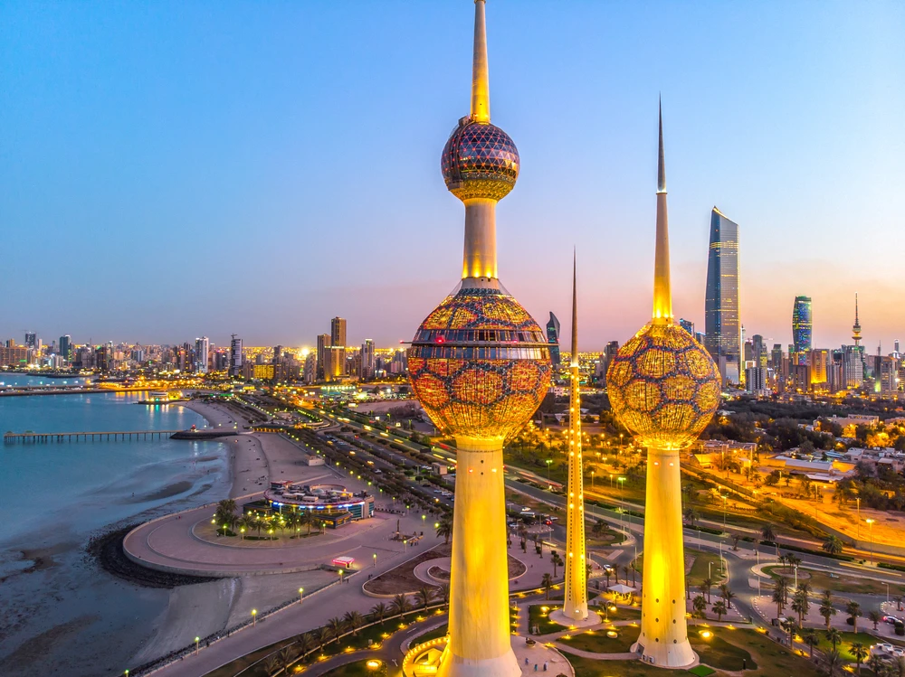 Kuwait Towers against the skyscrapers of Kuwait City during sunset. (Shutterstock)