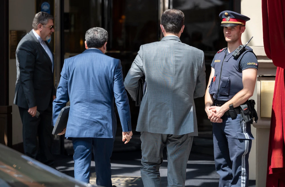 Abbas Araghchi (C-L), political deputy at Iran’s Foreign Ministry, and Iran’s Governor to the International Atomic Energy Agency, Kazem Gharib Abadi (C-R) are returning to the ‘Grand Hotel Wien’ during closed-door nuclear talks in Vienna. (File/AFP)